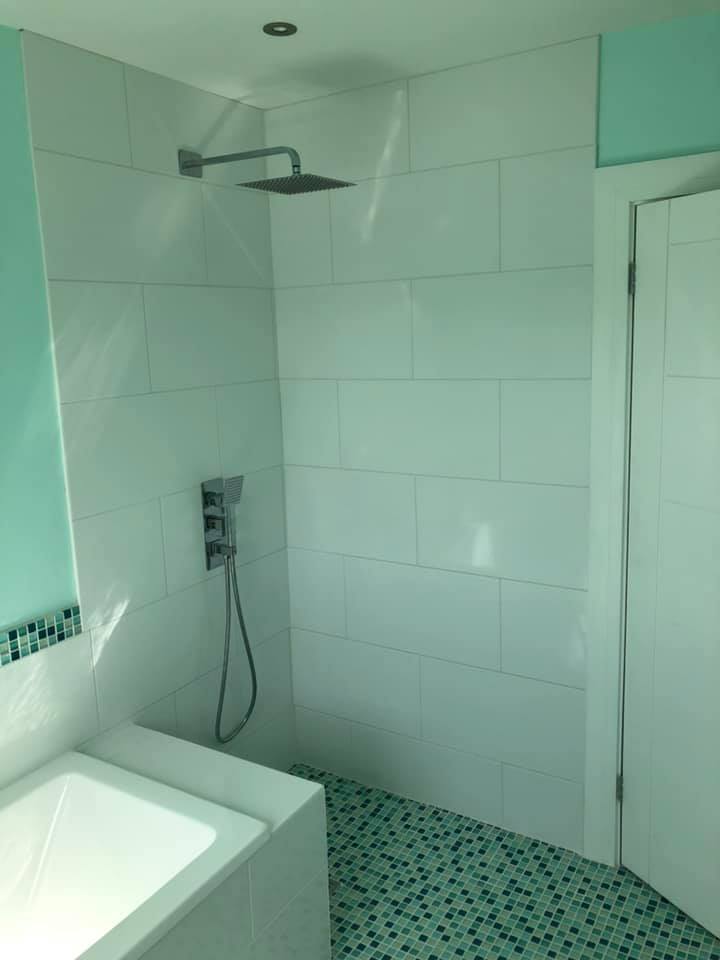 Mint coloured bathroom installation looking at the shower.