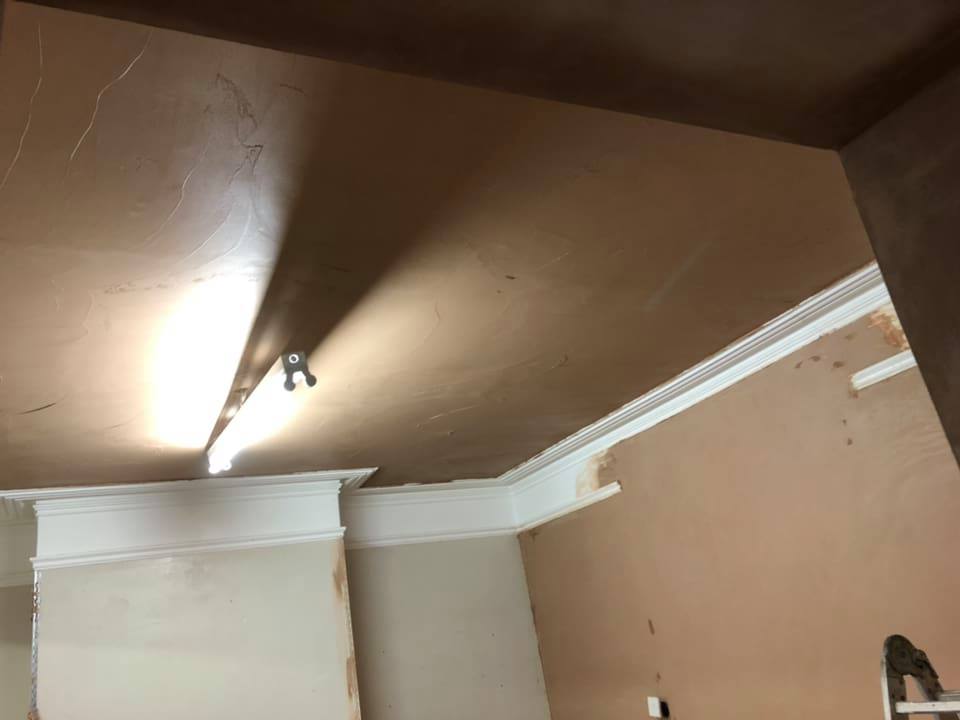 Plastering and rendering work on ceiling.